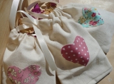 Calico Bags with Herbs/Tea/Pot Pourri - choose either just the bags to fill with your own favours or let us fill them for you with hand blended herbs, herbal and floral teas or scented pot pourri.<br /><br />7 x 9 cm unbleached cotton calico drawstring bags with fabric heart detail and colour coordinating ties<br /><br />Colours can be customised to match your day